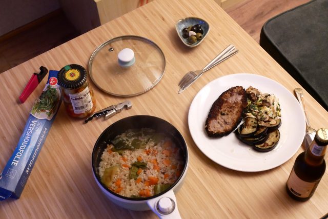 Pork cutlet dinner plate and seasoning rice hot pot on the wooden table