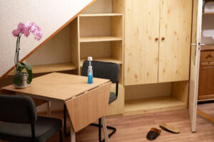 Flowers on the wooden table in the blank room in the Netherlands