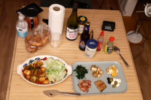 Tomato simmered vegetables, 6 kind of dishes on the plate and a wine bottle on the wooden table