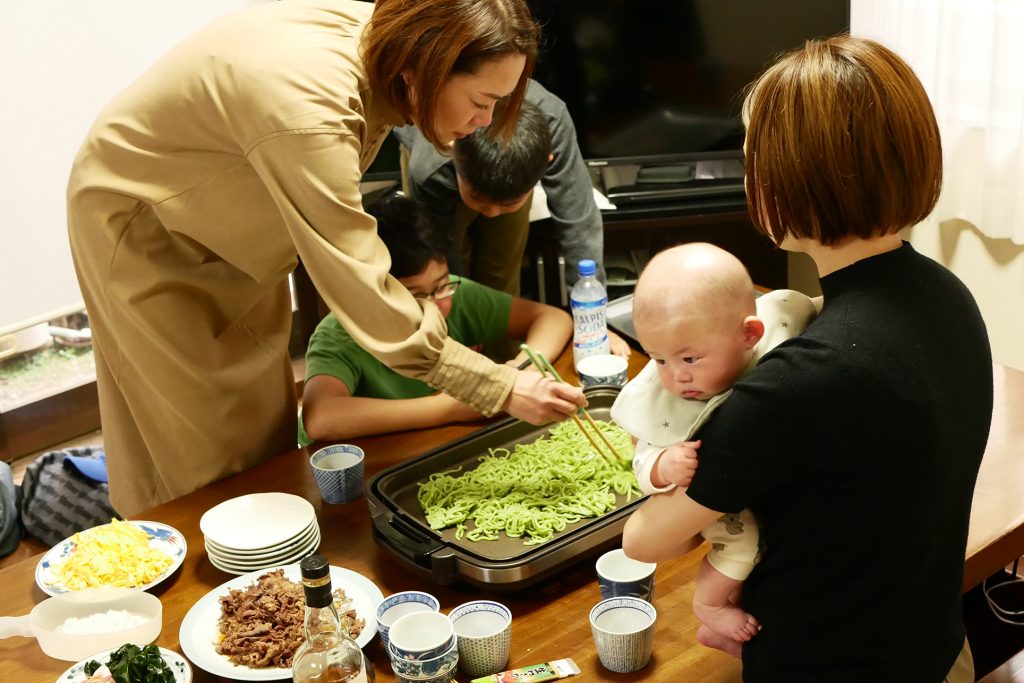 View of family party, they are cooking kawara soba