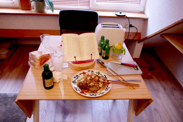 Dirty dinner in my room, there are yakisoba and book