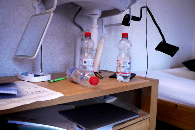 Water bottles on the wooden shelves