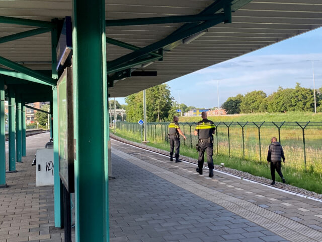 Police and suspect running on the railway