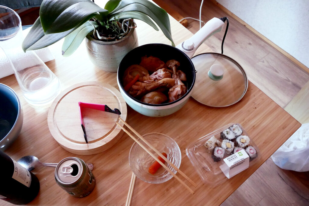 Simmered chicken pot on the table, packed sushi in the Netherlands
