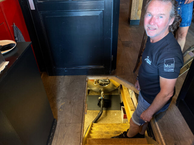 A dutch man shows a basement beer tank