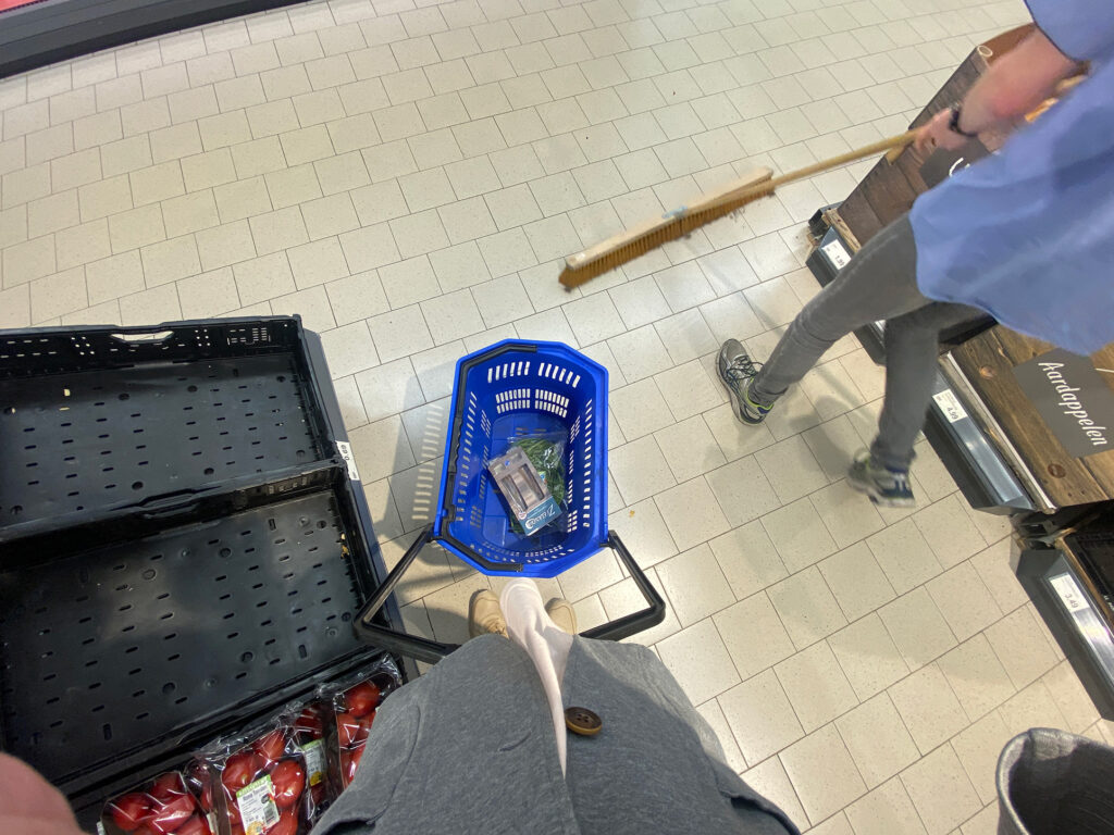 Floor at a supermarket in the Netherlands, there are basket, a man wiped floor