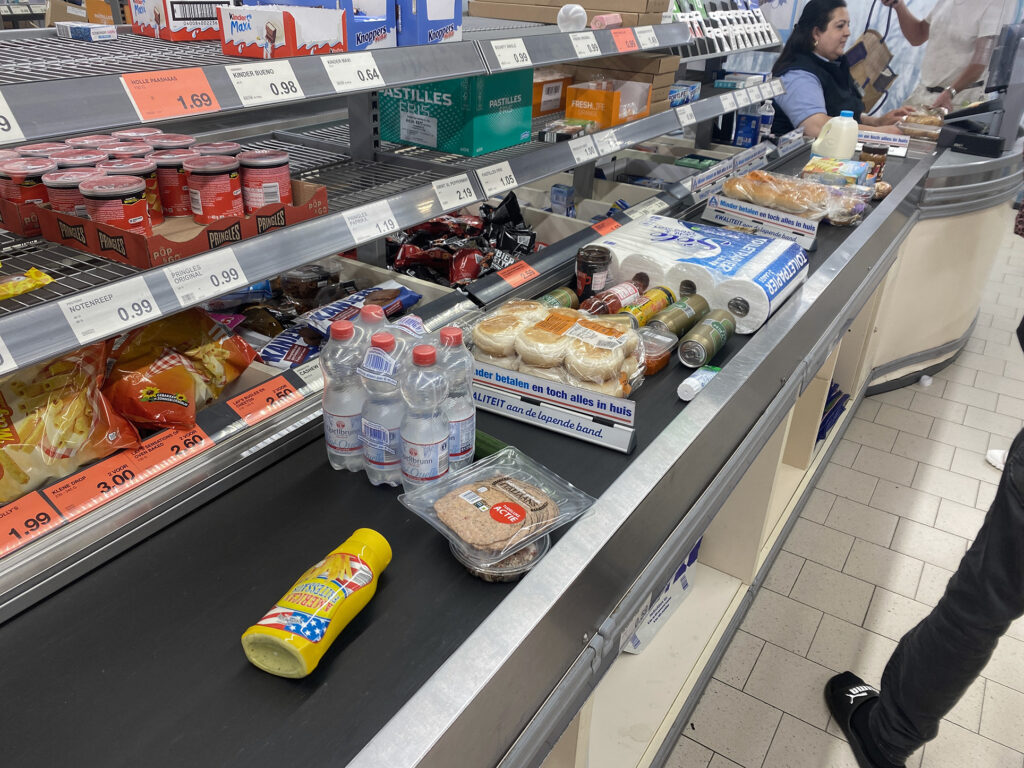 Supermarket counter, there are foods and daily products on the belt conveyor in the Netherlands