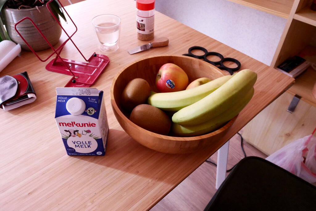 fruit on the wooden bowl and packed milk