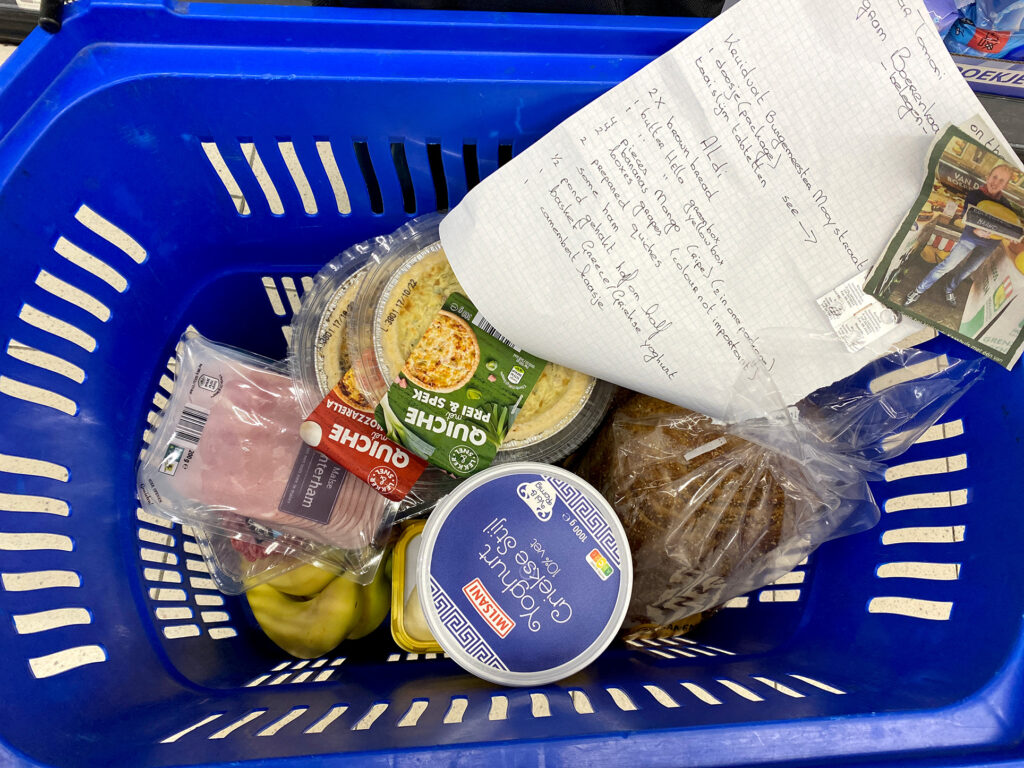dutch memo and groceries in the blue basket at the supermarket