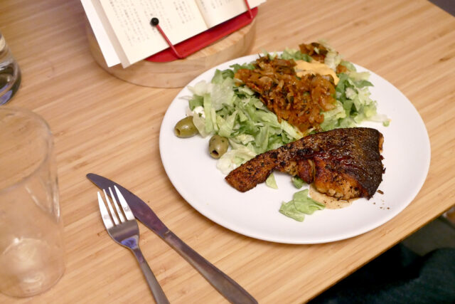 salmon fillet on the table and book