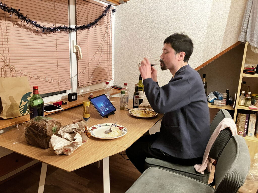 a Japanese drinking red wine in his room in the holland