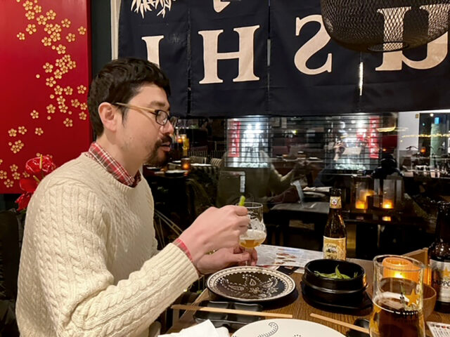 asian man eating and drinking at chinese running jI'm not feelin japanese restaurant